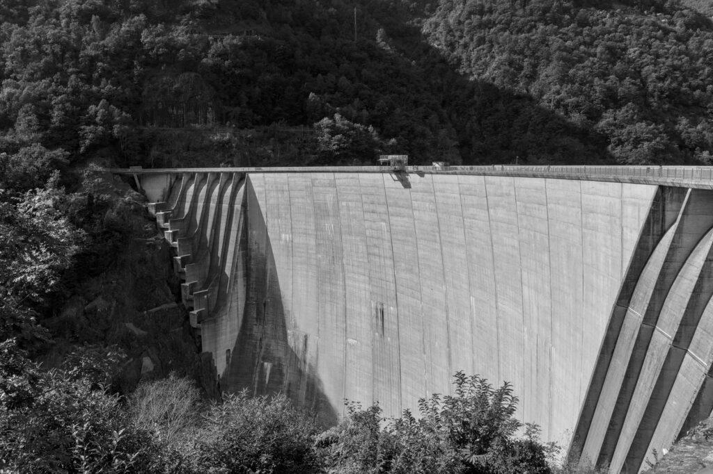 Black and white image of the iconic Verzasca Dam in Ticino, Switzerland.
