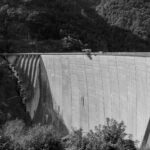 Black and white image of the iconic Verzasca Dam in Ticino, Switzerland.