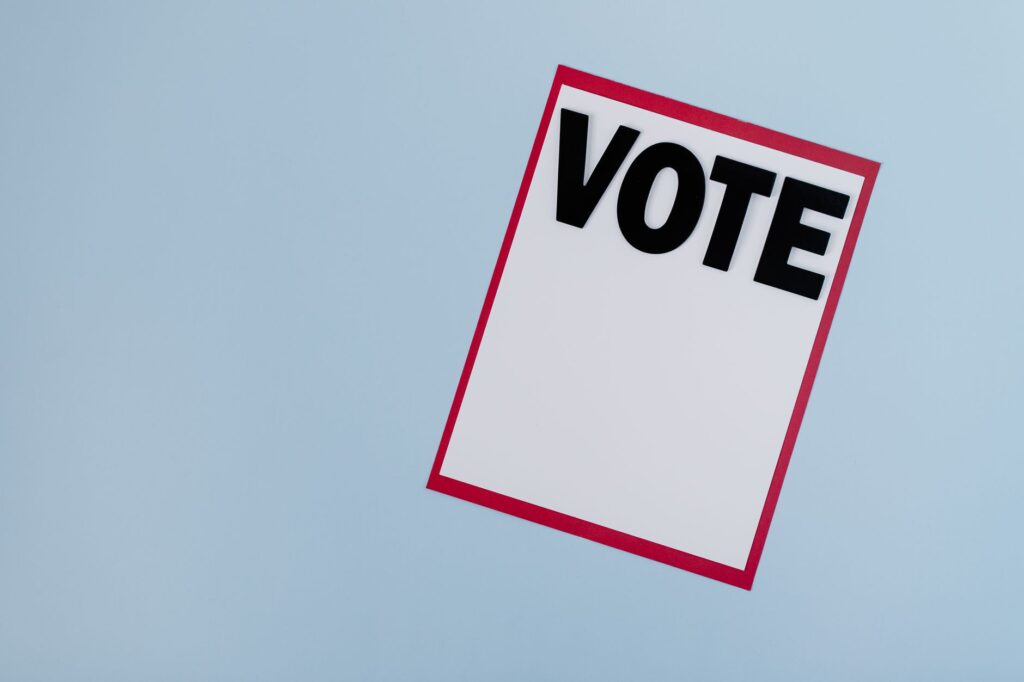 Minimalist vote card on a blue background, symbolizing election and democracy.