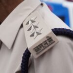 Detailed view of a police officer's shoulder insignia in India.