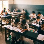 Elementary school children studying in a classroom, focusing intently on their work.