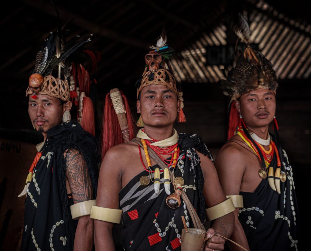 Three men in traditional tribal attire from Nagaland, India, embodying rich cultural heritage.