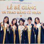 Group of graduates celebrating at a Vietnamese university graduation ceremony.