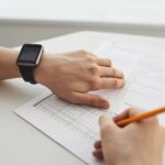 Student completing a multiple-choice exam with a pencil, close-up view.
