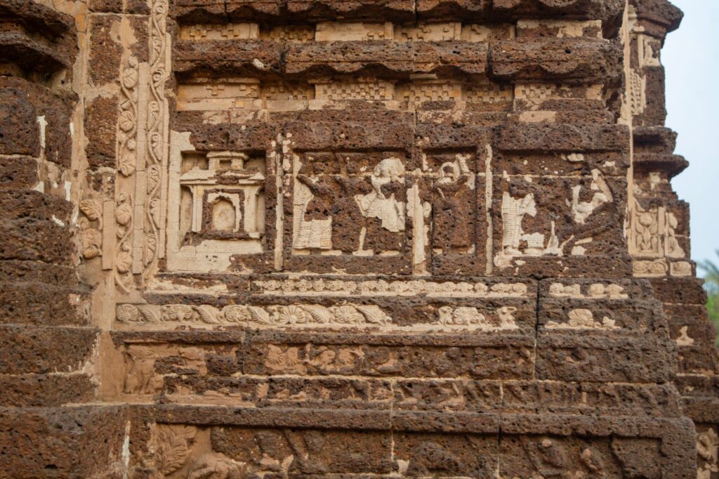 Detailed terracotta carvings on ancient temple wall in Bishnupur, West Bengal, India.