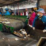 Workers sorting waste in a recycling facility in Butwal, Nepal, showcasing environmental sustainability efforts.