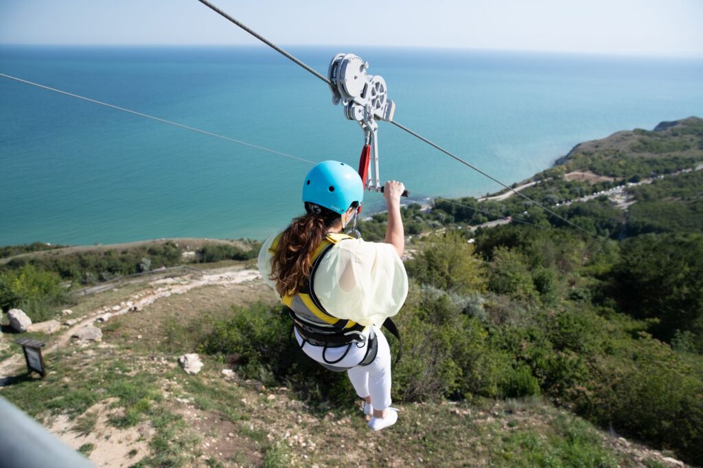 Experience the thrill of ziplining over a scenic Bulgarian landscape with breathtaking sea views.