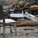 Destruction in Mocoa, Colombia shows a damaged chair amidst debris and rubble, highlighting natural disaster's impact.