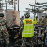 Nepali Army rescuers in action at a disaster site, collaborating amidst damaged infrastructure.