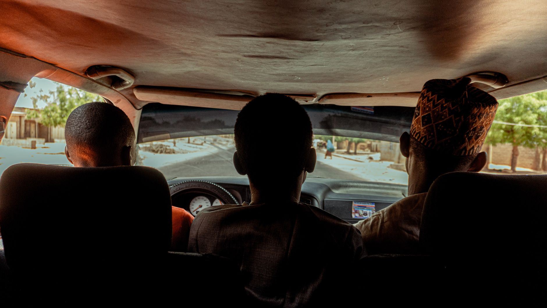 A scenic road trip view from the backseat of a car driving in Daura, Nigeria.