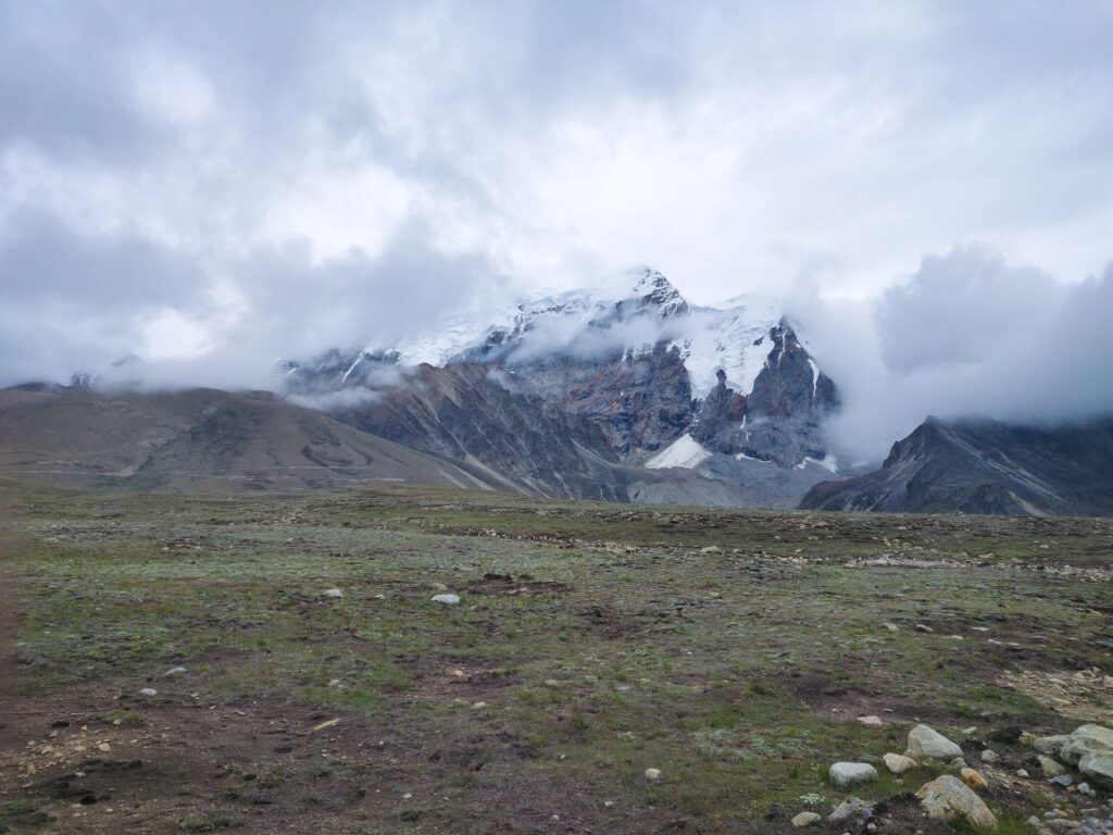 Breathtaking view of snow-capped mountains and clouds in North Sikkim, India.