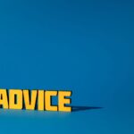 Yellow letters spelling 'Advice' on a vibrant blue background with ample copy space.