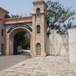 Stone entrance of a historic jail with arches and towers in Nanded, India.