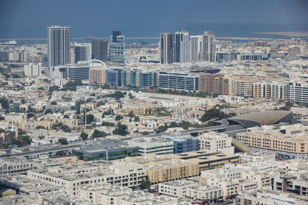 Expansive aerial shot capturing Dubai's modern cityscape with diverse architecture and bustling urban life.