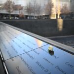White rose on engraved names at 9/11 Memorial, poignant tribute to 9/11 victims.
