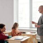 Teacher conducting a lesson with engaged students in a modern classroom setting.