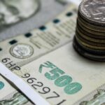 Detailed view of Indian rupees and stacked coins, representing currency and finance.