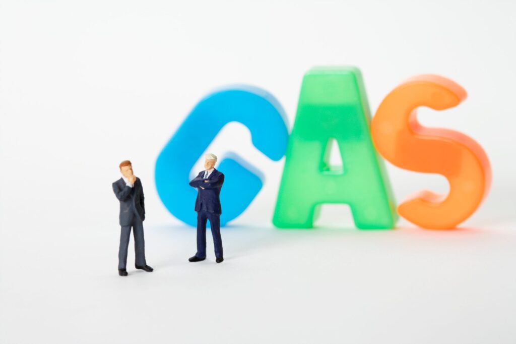 Creative image of toy businessmen with colorful gas letters, symbolizing industry concepts.