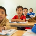 Young students focused and engaged while learning in a classroom environment.
