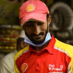 Shell V-Power employee wearing a red and yellow uniform in Lahore, Pakistan.