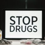 Tablet screen displaying anti-drug message surrounded by packaged substances, promoting awareness.