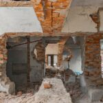 Explore the decaying ruins of an abandoned building with exposed bricks and destruction.