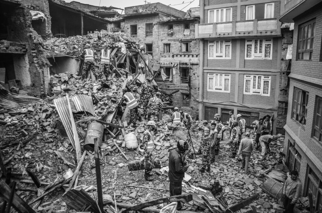 Rescue operations amidst earthquake destruction in Bhaktapur, Nepal. Soldiers sift through rubble.