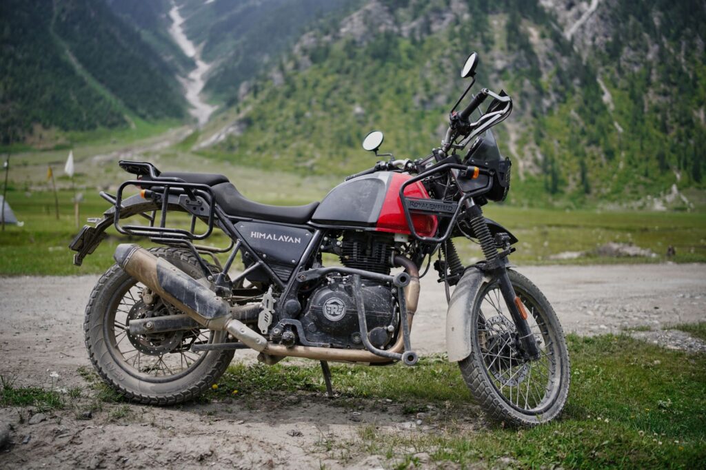 Royal Enfield Himalayan parked in a scenic mountainous landscape, ideal for off-road adventures.