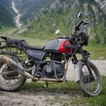 Royal Enfield Himalayan parked in a scenic mountainous landscape, ideal for off-road adventures.