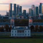 Capture the serene beauty of London's skyline at sunset with the historic Old Royal Naval College in the foreground.