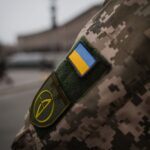 Detailed shot of Ukrainian military uniform with flag patch, symbolizing national pride.