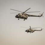 Two military helicopters flying in the sky above Belgrade, Serbia.