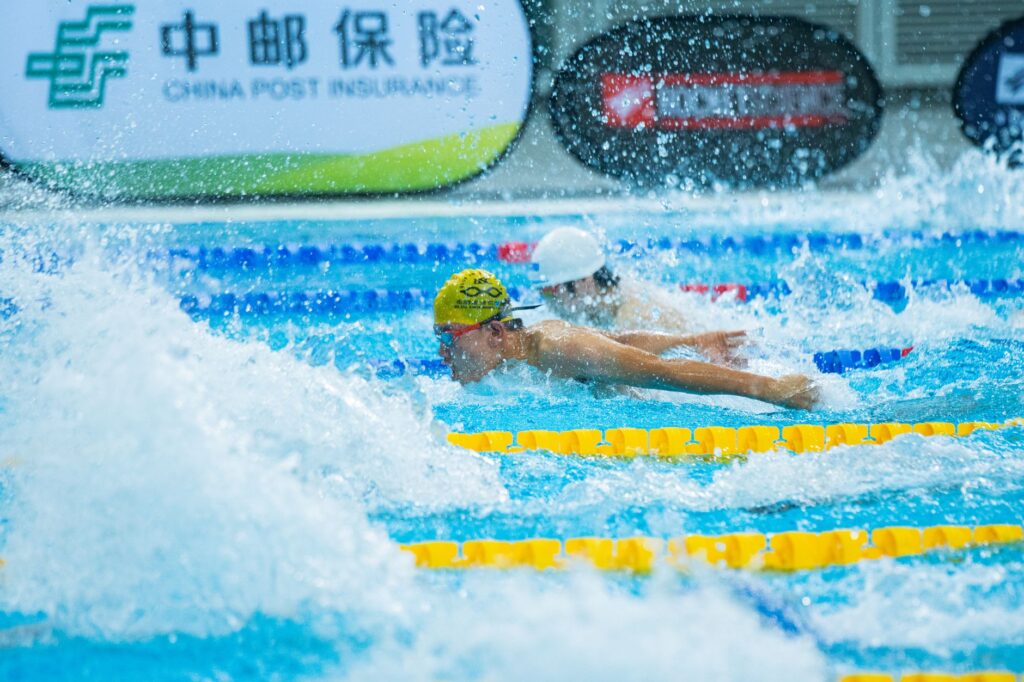 Two swimmers compete in a vibrant, action-packed swimming race.