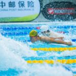 Two swimmers compete in a vibrant, action-packed swimming race.