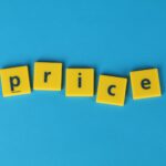 Yellow letter tiles spell the word 'price' against a vibrant blue backdrop, ideal for business concepts.
