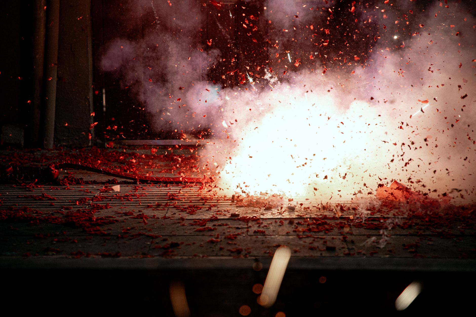 A mesmerizing explosion of firecrackers with vibrant red sparks lighting the scene.