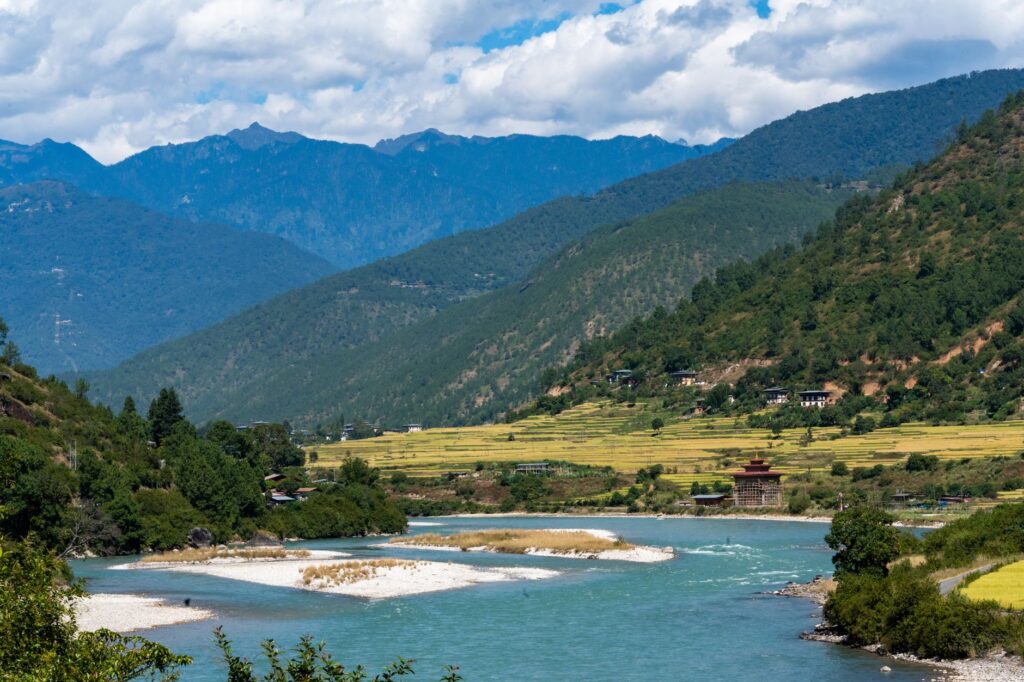 Picturesque landscape of the Punakha valley in Bhutan with lush greenery and mountains.