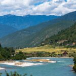 Picturesque landscape of the Punakha valley in Bhutan with lush greenery and mountains.