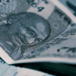 Detailed close-up of Indian Rupee banknotes with iconic Gandhi portrait, emphasizing economy and currency themes.
