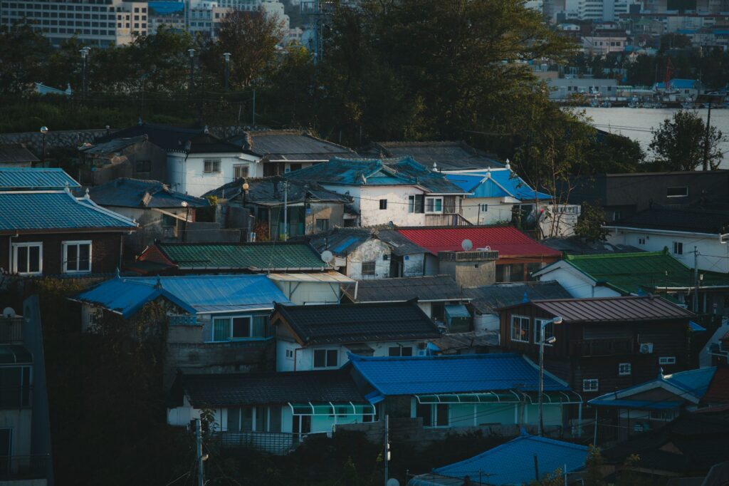 Aerial view of vibrant rooftops in Gangneung city, showcasing colorful architecture.