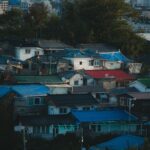 Aerial view of vibrant rooftops in Gangneung city, showcasing colorful architecture.