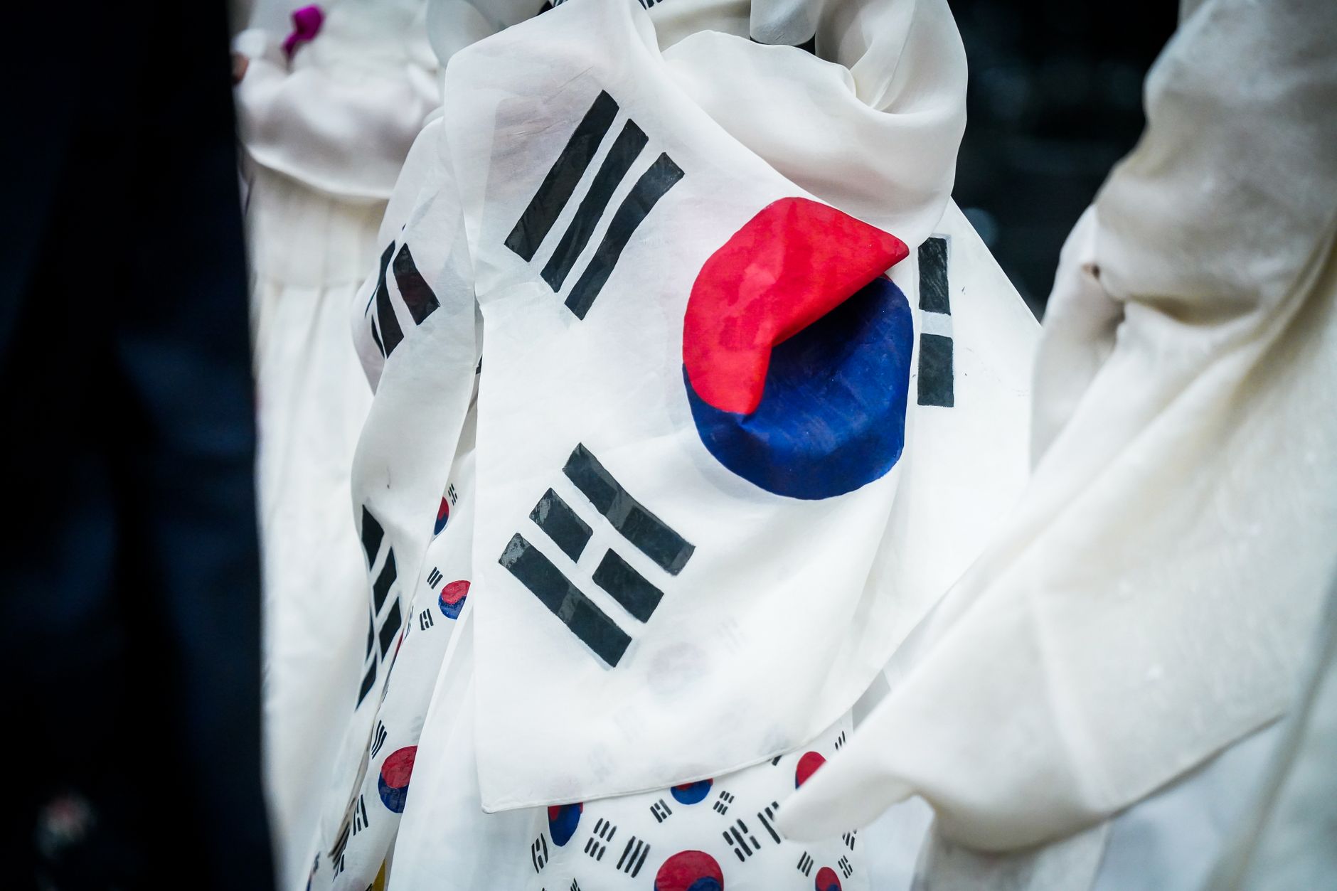 A detailed close-up of the wrinkled South Korean flag on fabric, showcasing its vibrant colors.
