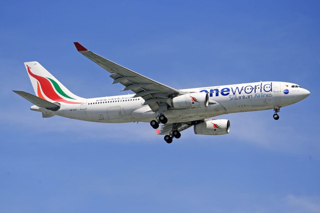 SriLankan Airlines Airbus A330 flying in clear blue skies, showcasing aviation in motion.
