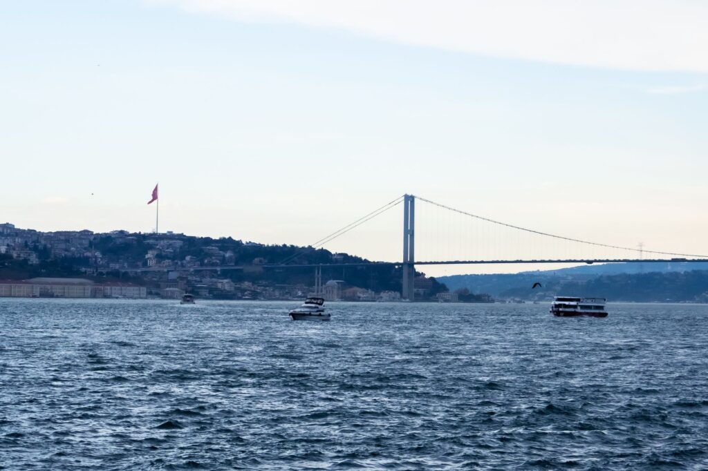 Scenic view of the Bosphorus Bridge and boats on Bosphorus Strait in Istanbul, Turkey.