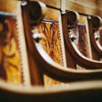 Close-up of ornate wooden chairs inside the Swiss Parliament building in Bern, Switzerland.