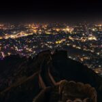 Captivating cityscape of Jaipur at night, seen from Nahargarh Fort's hilltop.