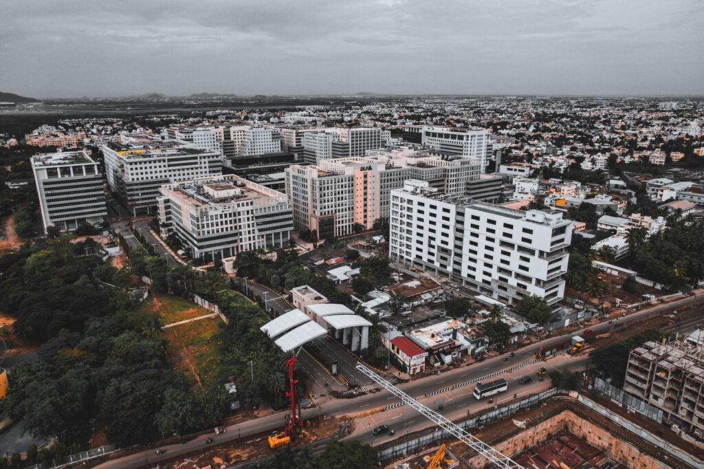 Drone shot capturing Chennai's bustling cityscape and modern architecture from above.