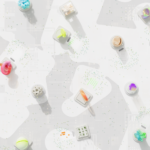 A vibrant 3D render of geometric shapes scattered over a circuit-like background.
