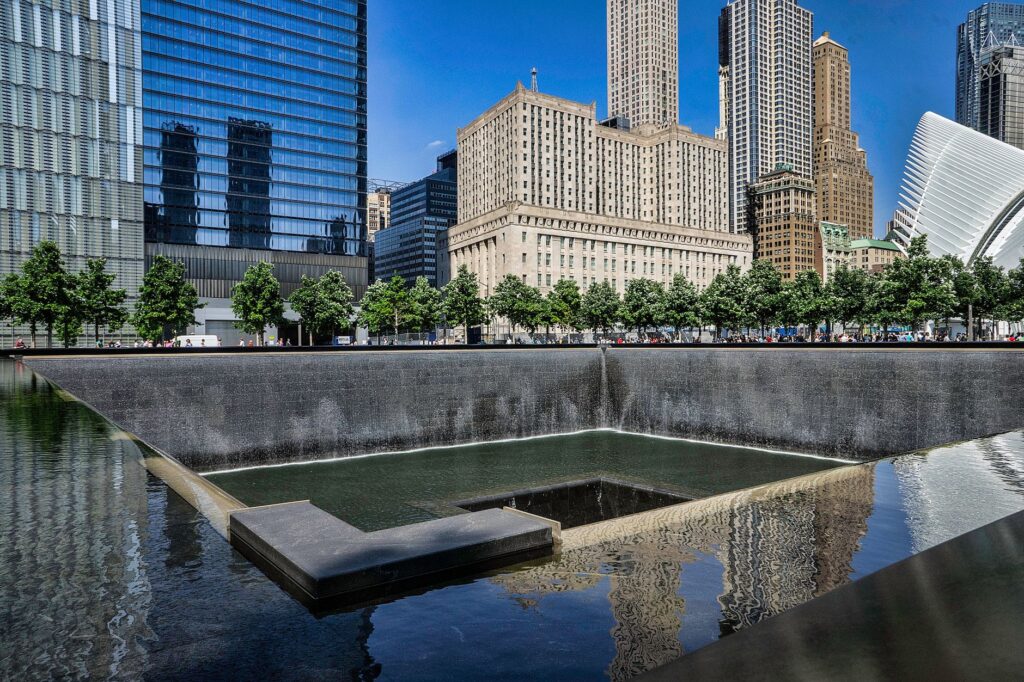 Stunning view of a city skyline with reflecting pool and vibrant urban architecture.