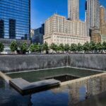 Stunning view of a city skyline with reflecting pool and vibrant urban architecture.